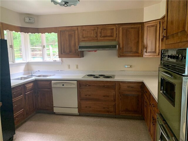 kitchen with sink, ventilation hood, and white appliances