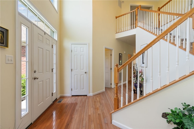 foyer with a high ceiling and light wood-type flooring