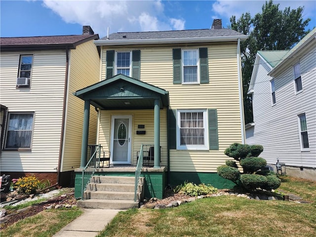 view of front of house featuring a front yard and cooling unit