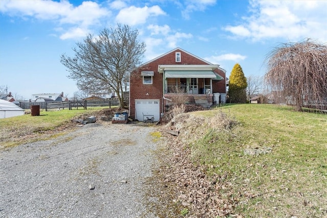 view of front of home with a garage and a front yard