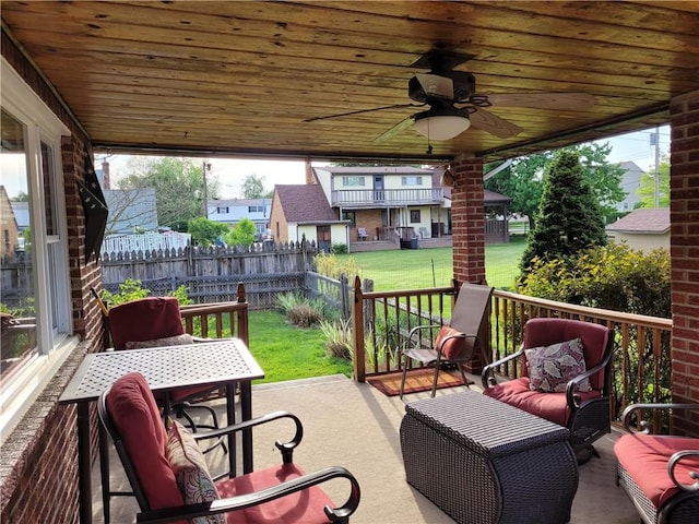 view of patio featuring ceiling fan and fence