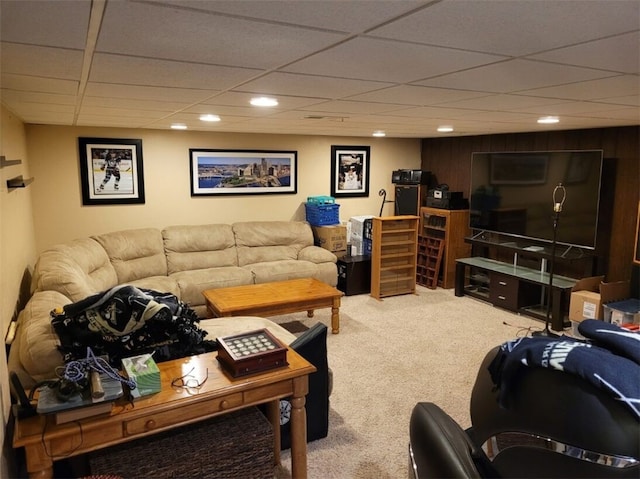 carpeted living area with a paneled ceiling and recessed lighting