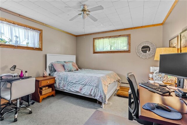 carpeted bedroom with ornamental molding, ceiling fan, and a baseboard radiator