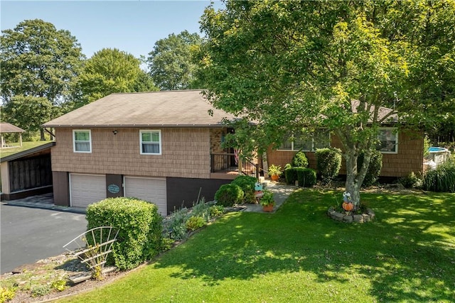 view of front of home with a garage, a carport, and a front lawn