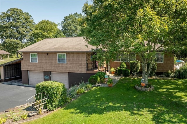 view of front of home with a front yard, a garage, and a carport