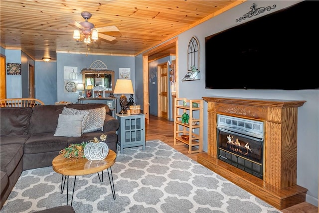 living room with ornamental molding, hardwood / wood-style floors, ceiling fan, and wood ceiling