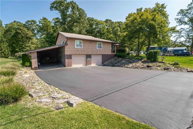 view of side of property featuring a carport and a garage