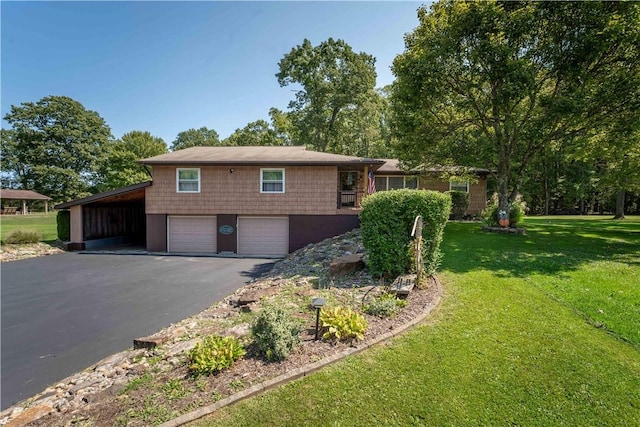 view of front of property with a carport, a garage, and a front yard