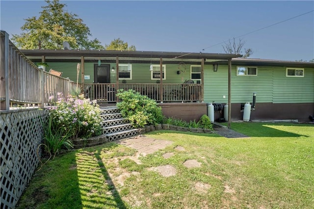 rear view of property with a lawn