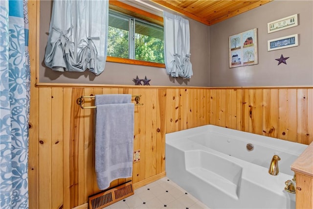 bathroom with a tub to relax in, wooden walls, and wooden ceiling