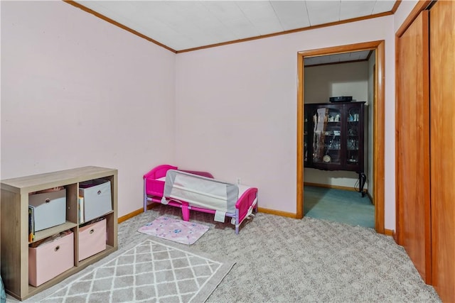 carpeted bedroom with ornamental molding and a closet