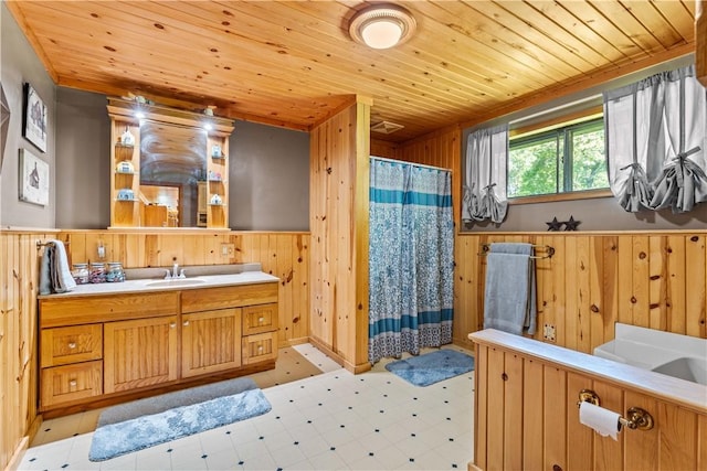 bathroom with curtained shower, vanity, wood walls, and wood ceiling