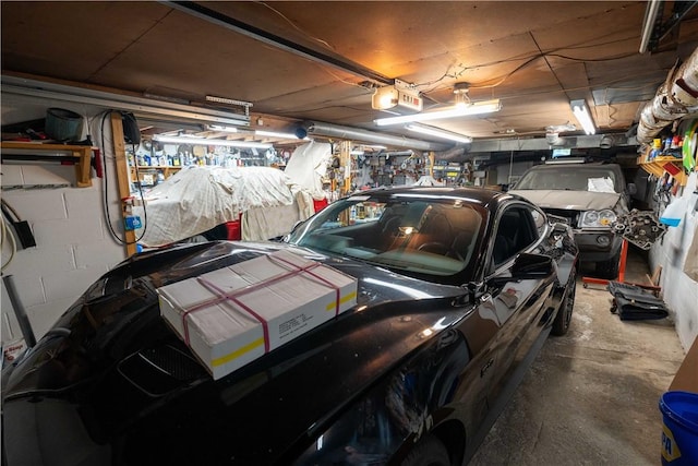 garage with a garage door opener and a workshop area