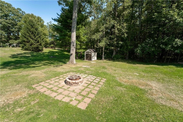 view of yard featuring a storage unit and a fire pit