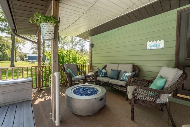 view of patio featuring an outdoor living space with a fire pit