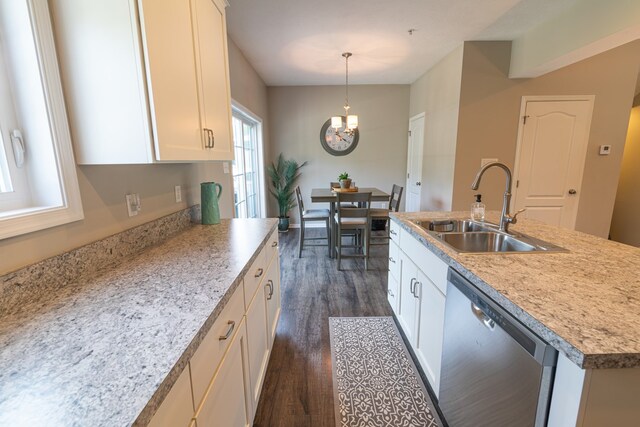 kitchen featuring dishwasher, sink, a center island with sink, decorative light fixtures, and dark hardwood / wood-style flooring