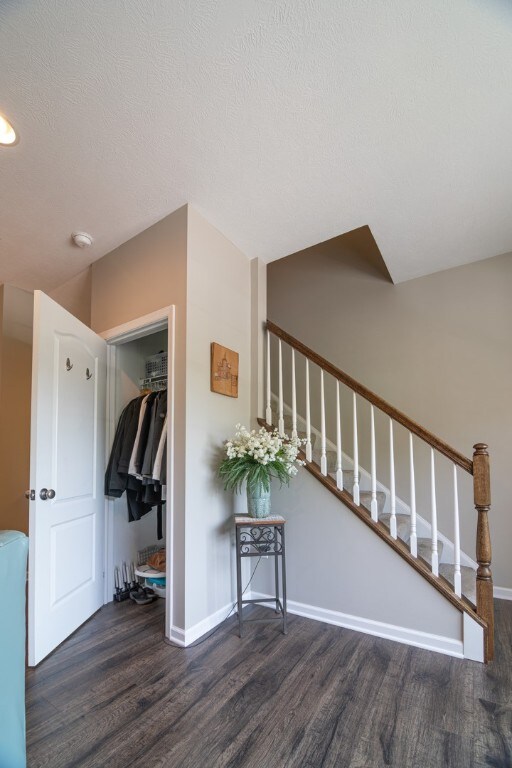 interior space featuring a textured ceiling and dark hardwood / wood-style flooring