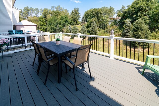 wooden terrace with a lawn and an outbuilding