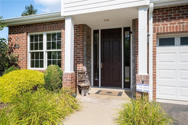 view of exterior entry featuring a garage