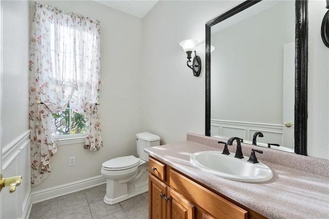 bathroom featuring vanity, tile patterned flooring, and toilet