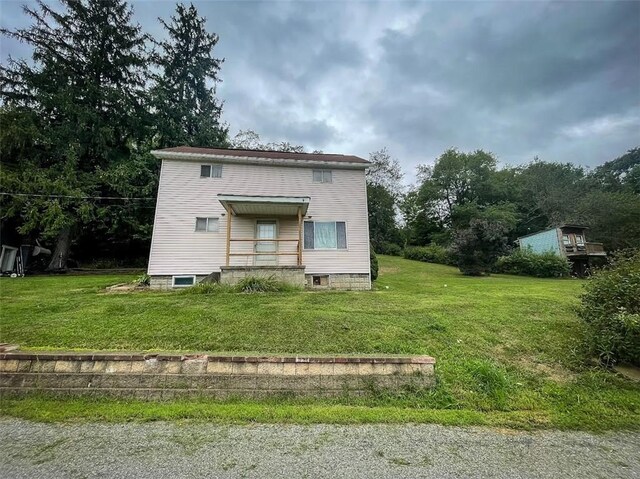 rear view of property with a yard