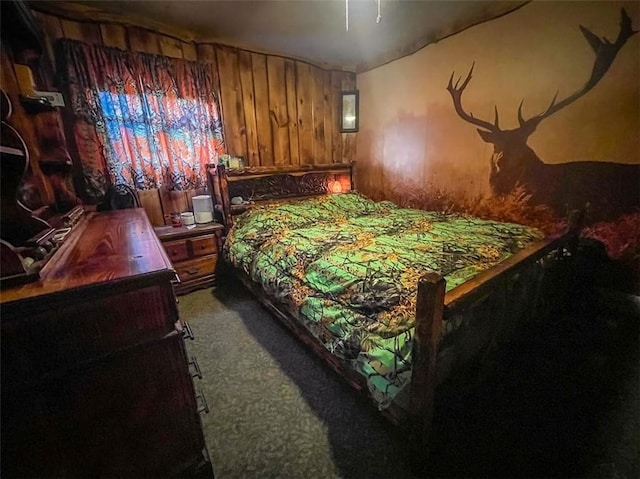 carpeted bedroom with wooden walls