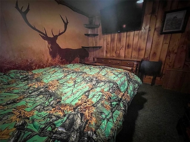 bedroom featuring carpet floors and wooden walls