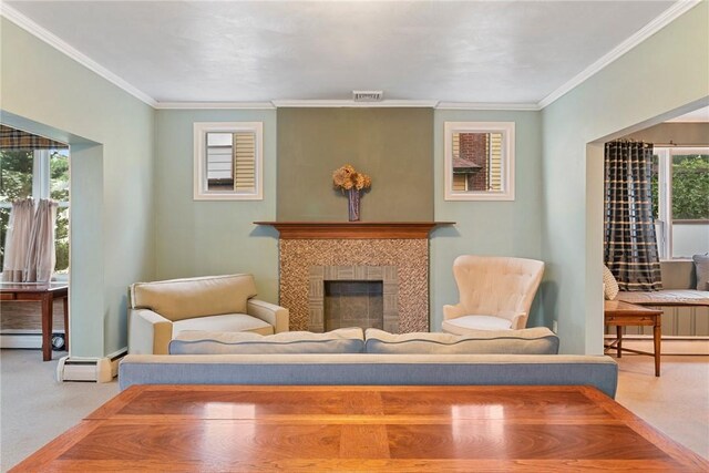 sitting room with a healthy amount of sunlight, a tiled fireplace, light colored carpet, and ornamental molding