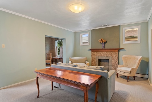 living room with light carpet, baseboard heating, a tiled fireplace, and crown molding