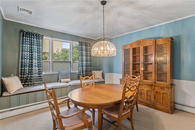 dining space with a baseboard heating unit, carpet, ornamental molding, and an inviting chandelier