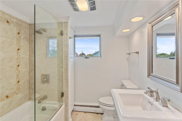 full bathroom featuring tile patterned flooring, toilet, sink, and plenty of natural light