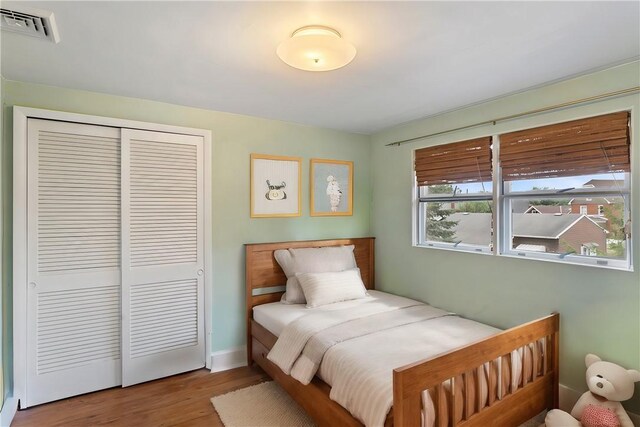 bedroom with wood-type flooring and a closet