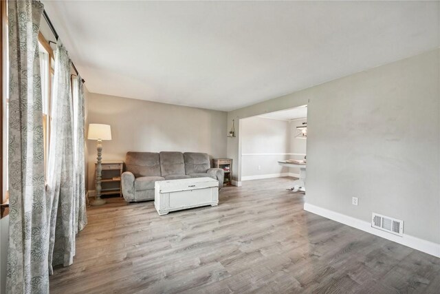 unfurnished living room with wood-type flooring