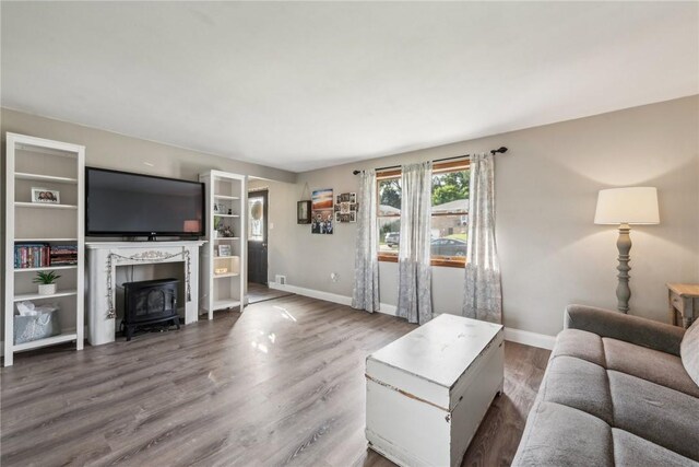 living room with a fireplace and hardwood / wood-style floors