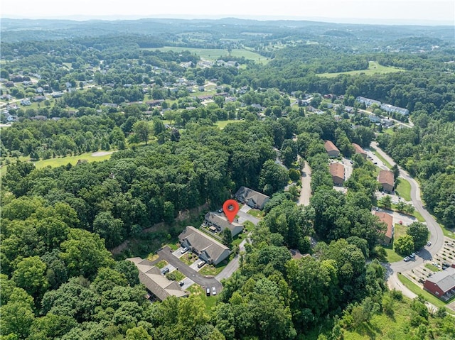 birds eye view of property with a view of trees