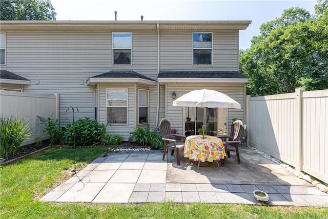 back of house featuring a patio area and a fenced backyard