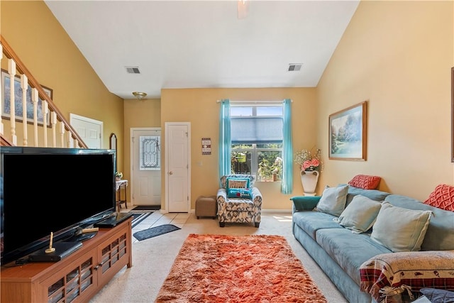 living room with light colored carpet, visible vents, stairway, and baseboards