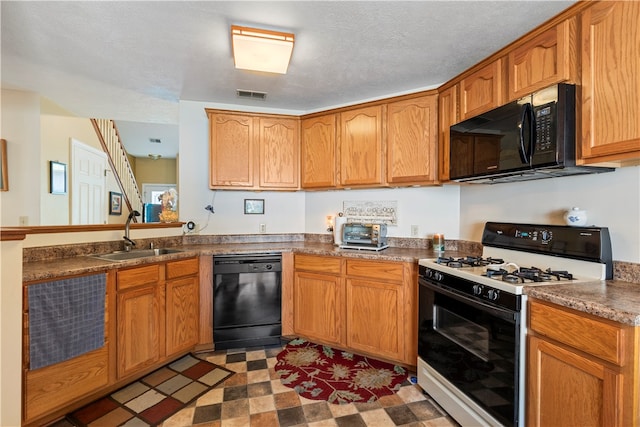 kitchen featuring light tile patterned flooring, black appliances, sink, a textured ceiling, and kitchen peninsula