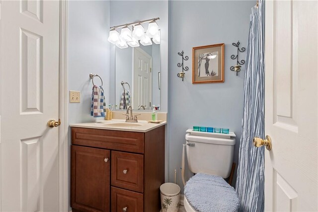 bathroom featuring toilet and vanity