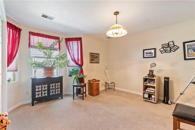 sitting room with light colored carpet, visible vents, and baseboards