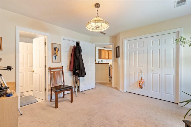 bedroom with multiple closets, light colored carpet, visible vents, and baseboards