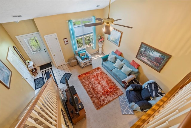 living room with high vaulted ceiling, visible vents, and a ceiling fan