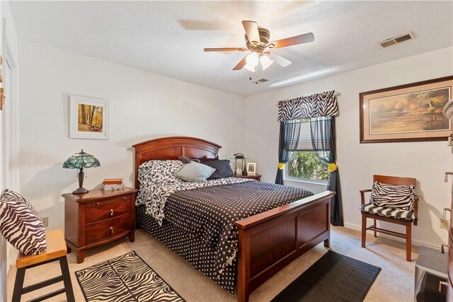 bedroom featuring light carpet and ceiling fan