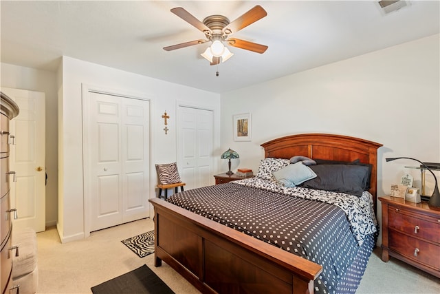 bedroom featuring light carpet and ceiling fan