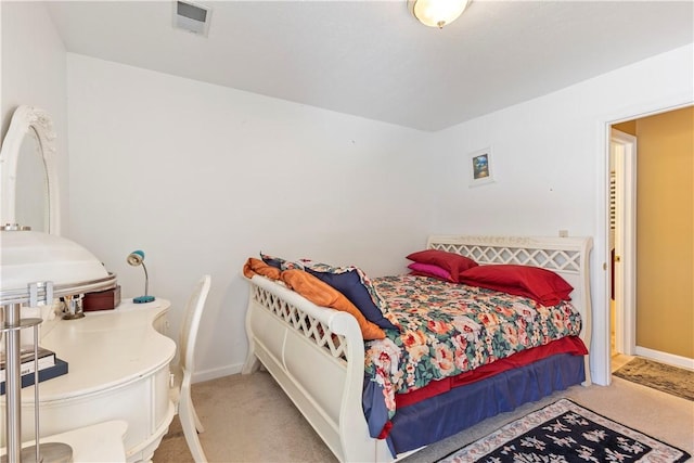 carpeted bedroom featuring baseboards and visible vents