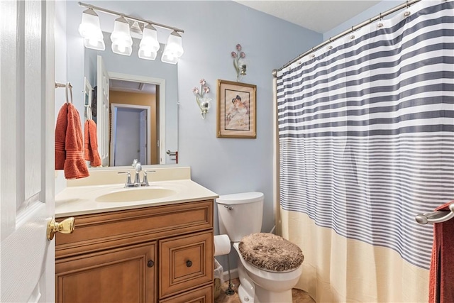 bathroom featuring toilet and vanity