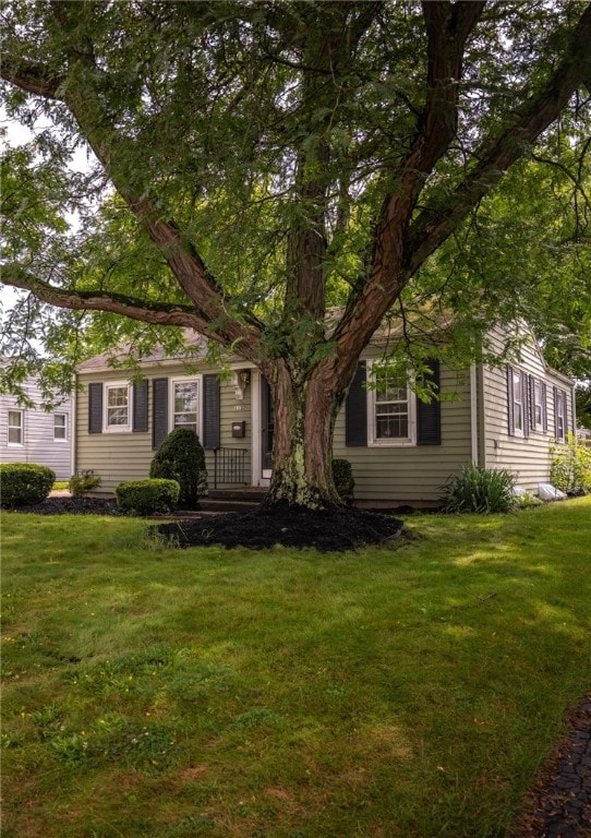 obstructed view of property with a front yard