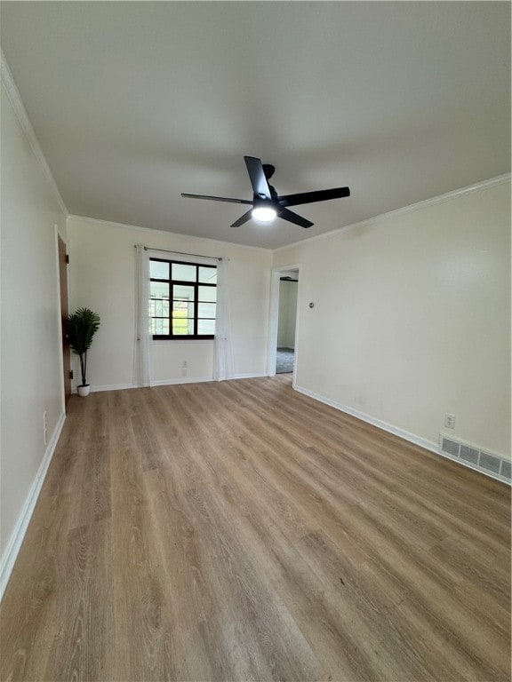 unfurnished living room featuring light hardwood / wood-style flooring, ornamental molding, and ceiling fan