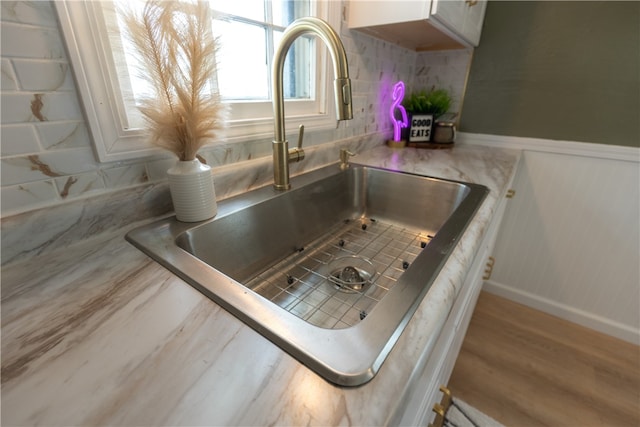 details with sink, tasteful backsplash, and hardwood / wood-style floors