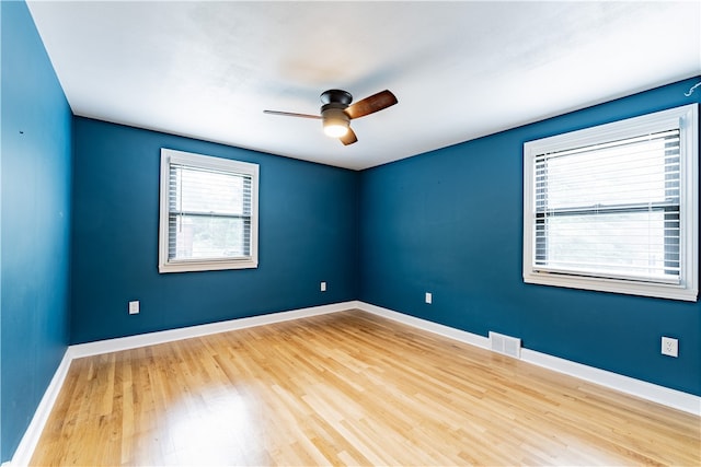 spare room with hardwood / wood-style floors and ceiling fan